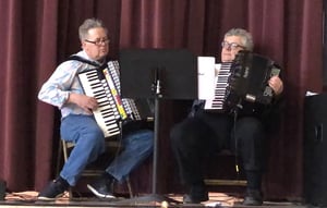 Dave Doolin (left) and author Bill Schmitt (right) play their accordions at a parish festival honoring St. Joseph on March 19.