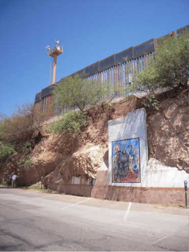 U.S. Border Patrol watchtower, border fence, and mural of Santa Muerte (Nogales, Sonora, Mexico); photo used with permission of Kino Border Initiative.